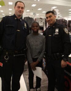 A man standing between two police officers in a store.