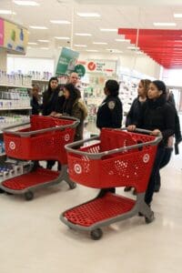 A group of people in a store with shopping carts.