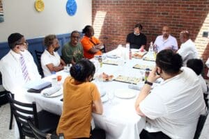 A group of people sitting around a table eating.