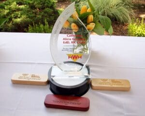 A glass award sitting on top of a table.