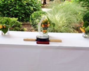 A table with a white cloth and some plants