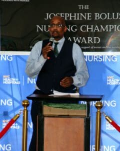 A man standing at the podium speaking to an audience.