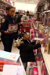 A young boy is shopping for toys at the toy store.