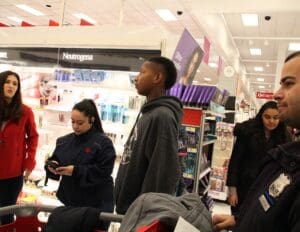 A group of people standing around in a store.