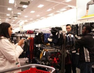 A man is taking a picture of another man in a store.