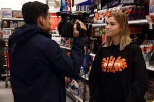 A man and woman are talking to someone in the store.