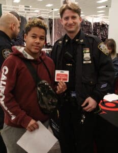 A man and boy in uniform posing for the camera.