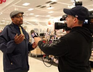 A man being interviewed by a tv camera.