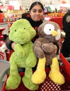 A person holding two stuffed animals in their arms.