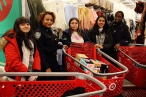 A group of people standing around shopping carts.