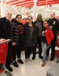 A group of people standing in front of red carts.