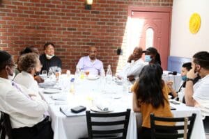 A group of people sitting at a table with wine glasses.