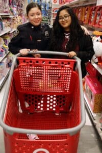 A woman is pushing a shopping cart in the store