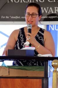 A woman is speaking at a podium with a microphone.