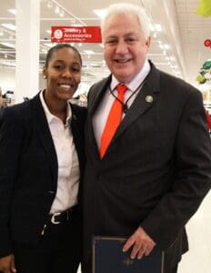 A man and woman posing for the camera in a store.