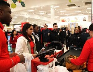 A group of people standing around in a store.