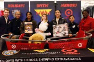 A group of people standing around baskets with toys.