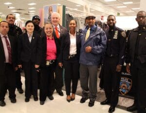 A group of people standing in front of a store.