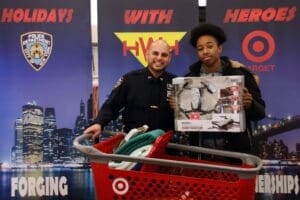 A man and woman holding a shopping cart.