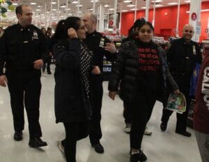 A group of people walking around in a store.