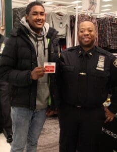 A man and a police officer standing next to each other.