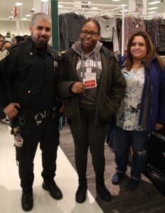 A man and two women posing for the camera.