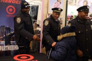 Two police officers standing next to a man.