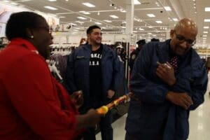 A group of people standing around in a store.