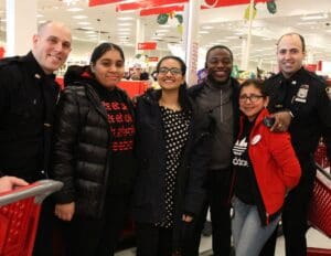 A group of people standing in front of a store.