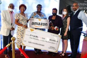 Four people holding a giant check and an amazon sign.