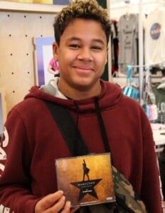 A young man holding up his cd case.