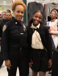 Two women in police uniforms posing for a picture.