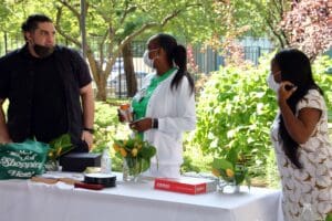 A woman standing at the table with flowers.