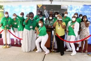 A group of people wearing masks and standing in front of a podium.